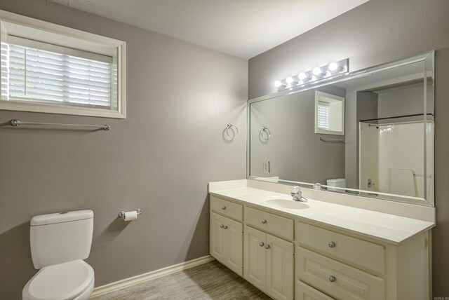 full bathroom featuring vanity, wood finished floors, and a shower