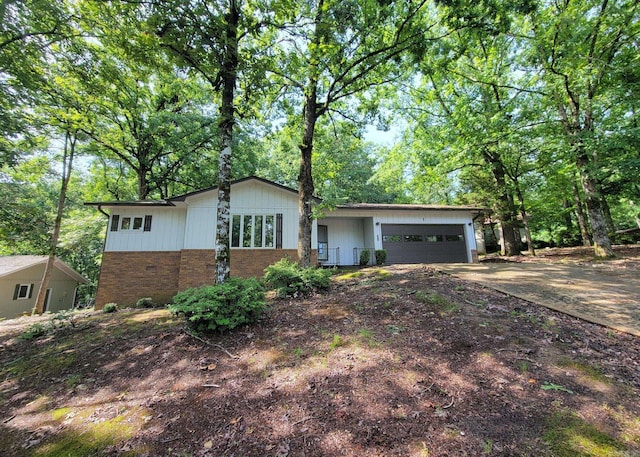 1 Sierra Ln, Hot Springs Village, AR 71909 - view of front facade with a garage, concrete driveway, and brick siding