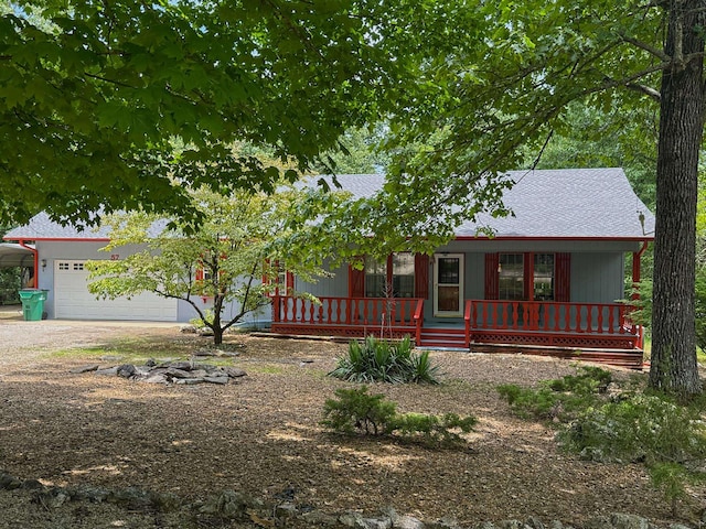57 Cherokee Acres Dr, Cherokee Village, AR 72529 - view of front of house with covered porch, driveway, an attached garage, a shingled roof, and a carport