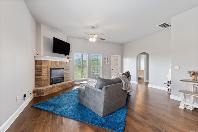 526 NW 62nd Ave, Bentonville, AR 72713 - living area featuring arched walkways, ceiling fan, wood finished floors, and a fireplace