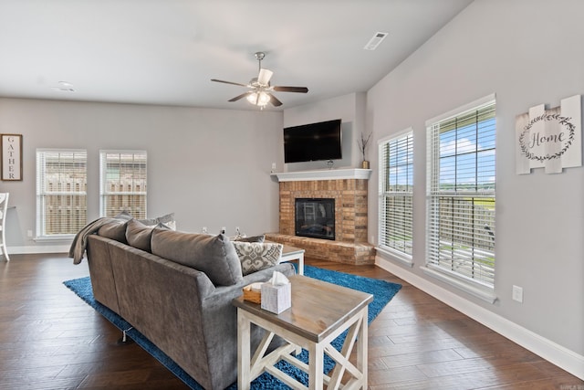 526 NW 62nd Ave, Bentonville, AR 72713 - living area with a ceiling fan, a brick fireplace, and dark wood-style flooring