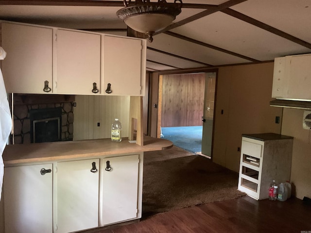 39 Holley Rd, Edgemont, AR 72044 - kitchen with white cabinets, a fireplace, dark wood-style floors, wood walls, and light countertops