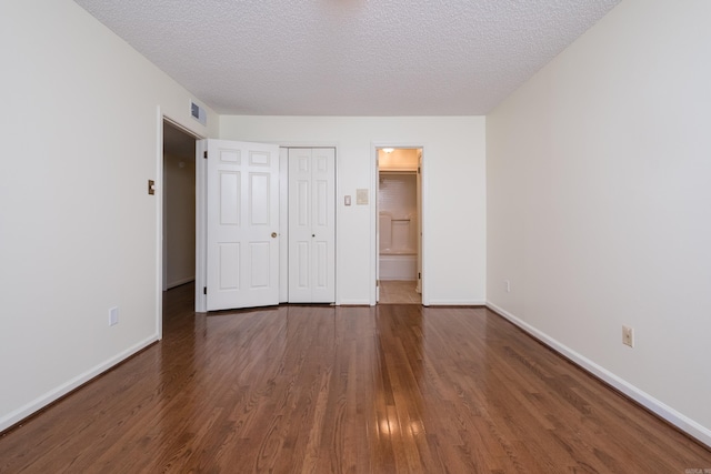 520 Cambridge Place Dr, Little Rock, AR 72227 - unfurnished bedroom with wood finished floors, a textured ceiling, ensuite bath, and a closet