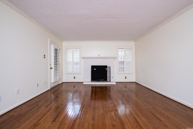 520 Cambridge Place Dr, Little Rock, AR 72227 - unfurnished living room with a textured ceiling, hardwood / wood-style floors, crown molding, plenty of natural light, and a brick fireplace