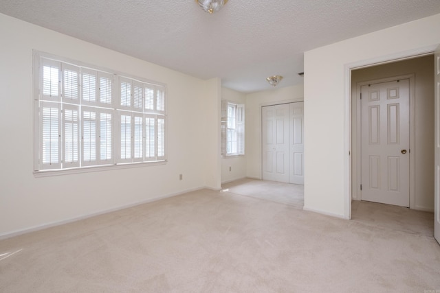 520 Cambridge Place Dr, Little Rock, AR 72227 - unfurnished bedroom with light colored carpet, a closet, and a textured ceiling