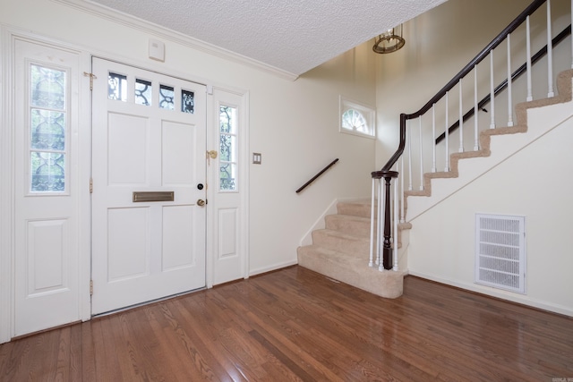 520 Cambridge Place Dr, Little Rock, AR 72227 - entryway featuring wood finished floors, stairs, a textured ceiling, and crown molding