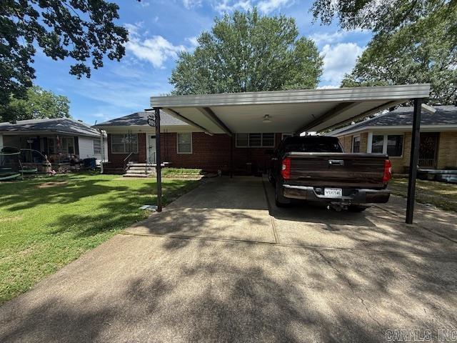 209 Crouch St, Benton, AR 72015 - view of front facade with concrete driveway, a front yard, and a carport
