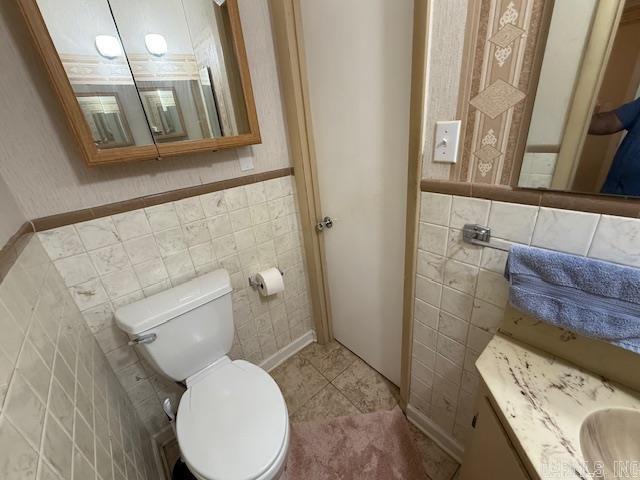 209 Crouch St, Benton, AR 72015 - half bathroom featuring tile walls, vanity, and wainscoting