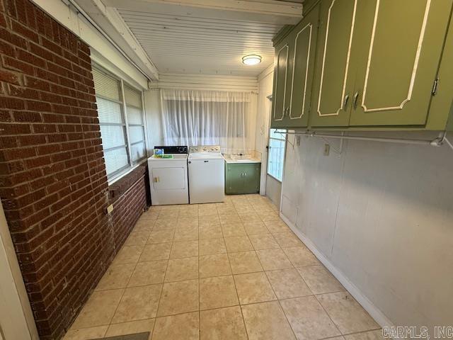 209 Crouch St, Benton, AR 72015 - washroom with brick wall, independent washer and dryer, cabinet space, and light tile patterned flooring