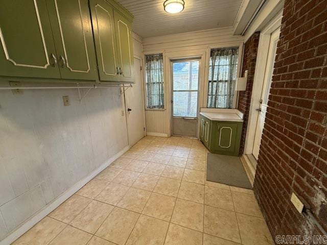209 Crouch St, Benton, AR 72015 - laundry area with brick wall and light tile patterned flooring