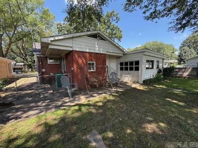 209 Crouch St, Benton, AR 72015 - rear view of property with brick siding and an attached garage