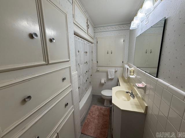 209 Crouch St, Benton, AR 72015 - bathroom featuring vanity, wallpapered walls, tile patterned floors, a wainscoted wall, and shower / bathtub combination with curtain