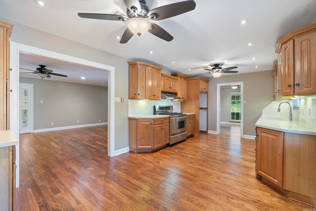 300 Beaconsfield Rd, Sherwood, AR 72120 - kitchen with stainless steel gas range oven, a ceiling fan, under cabinet range hood, light countertops, and recessed lighting