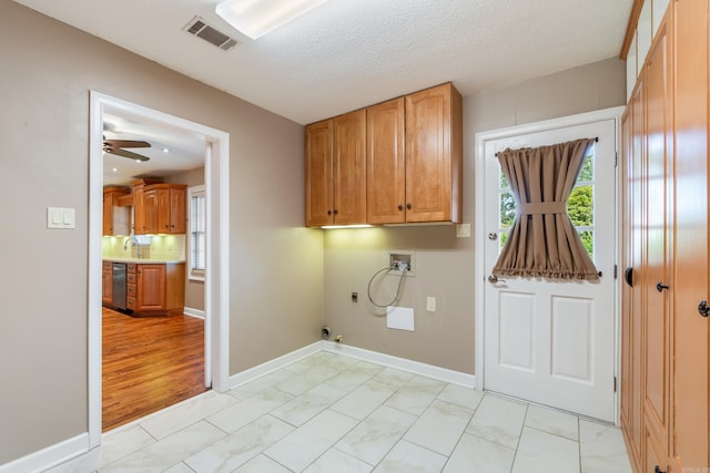 300 Beaconsfield Rd, Sherwood, AR 72120 - laundry area with hookup for a washing machine, cabinet space, electric dryer hookup, hookup for a gas dryer, and light marble finish flooring