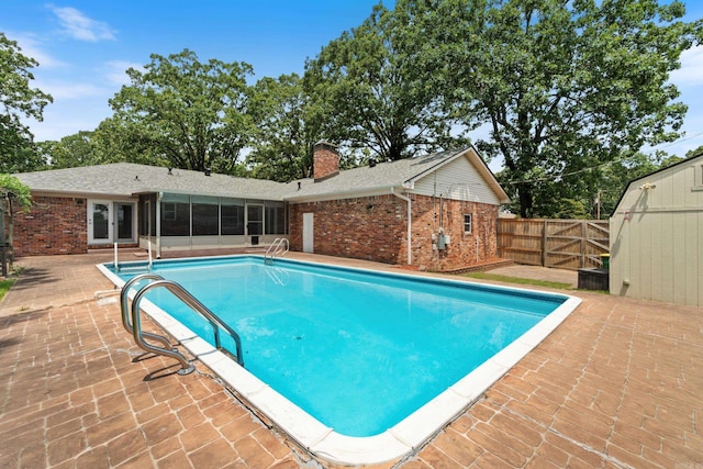 300 Beaconsfield Rd, Sherwood, AR 72120 - view of swimming pool featuring a patio area, a fenced backyard, a sunroom, and french doors