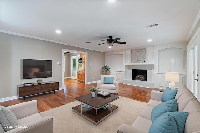 300 Beaconsfield Rd, Sherwood, AR 72120 - living room with wood finished floors, ornamental molding, ceiling fan, recessed lighting, and healthy amount of natural light