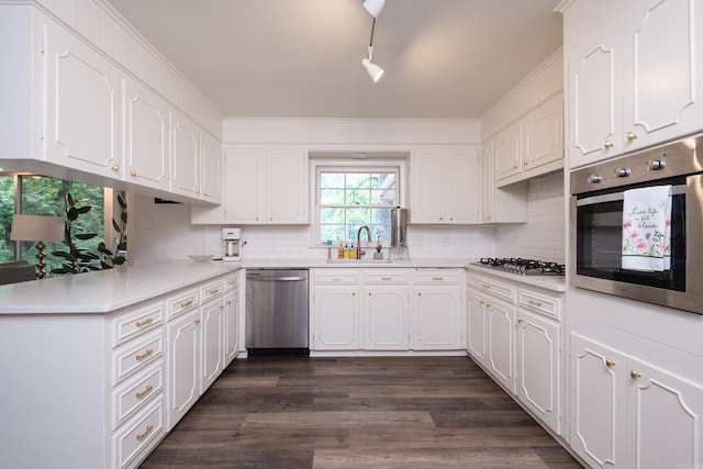20 Robinwood Rd, Little Rock, AR 72227 - kitchen featuring stainless steel appliances, white cabinetry, decorative backsplash, and light countertops