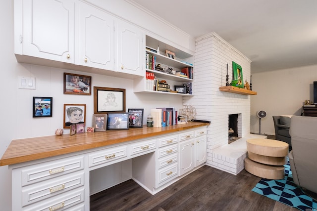 20 Robinwood Rd, Little Rock, AR 72227 - office space featuring built in desk, dark wood finished floors, and a brick fireplace