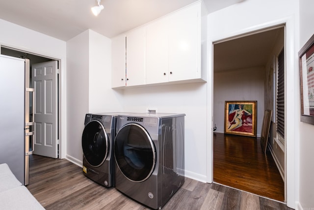 20 Robinwood Rd, Little Rock, AR 72227 - laundry room featuring independent washer and dryer, cabinet space, and dark wood-type flooring