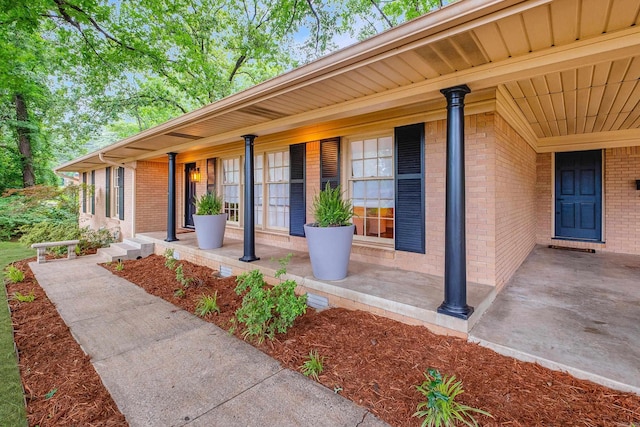 20 Robinwood Rd, Little Rock, AR 72227 - view of exterior entry featuring a porch and brick siding