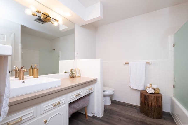 20 Robinwood Rd, Little Rock, AR 72227 - full bathroom featuring tile walls, vanity, wood finished floors, wainscoting, and shower / bathtub combination