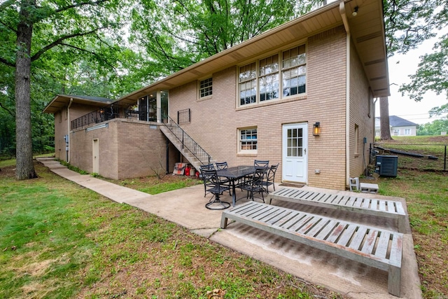 20 Robinwood Rd, Little Rock, AR 72227 - back of property featuring stairway, a patio area, a yard, and brick siding