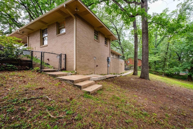 20 Robinwood Rd, Little Rock, AR 72227 - view of side of home with a gate and brick siding