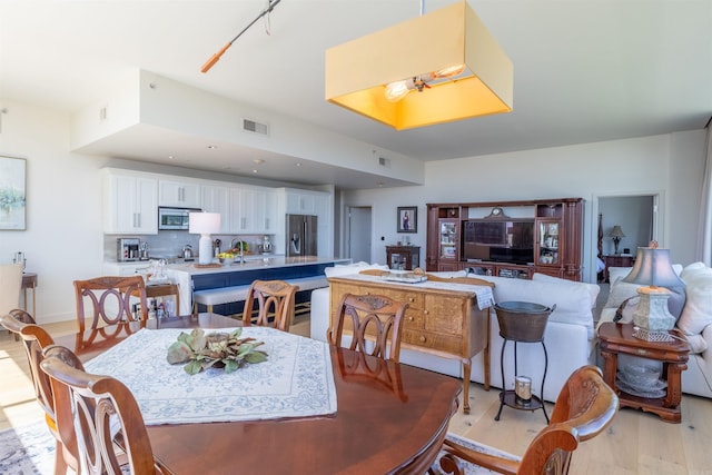 300 E 3rd St Unit 602, Little Rock, AR 72201 - dining space featuring light wood-type flooring and baseboards