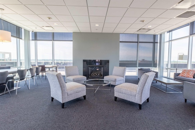300 E 3rd St Unit 602, Little Rock, AR 72201 - living room featuring a wall of windows, carpet floors, and a paneled ceiling