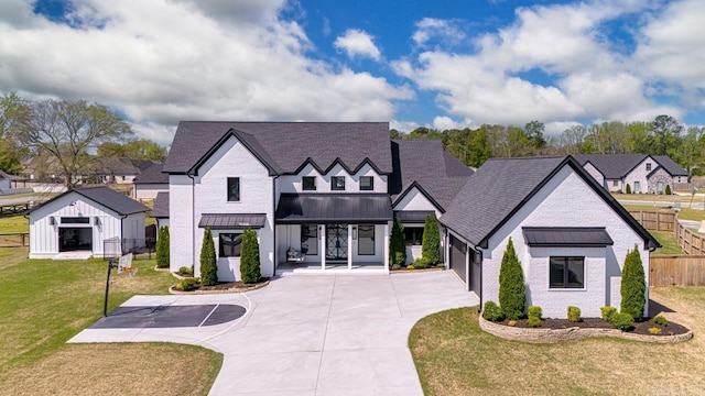 7509 S Shoreline, Benton, AR 72019 - modern farmhouse style home featuring a standing seam roof, concrete driveway, a metal roof, an attached garage, and a shingled roof