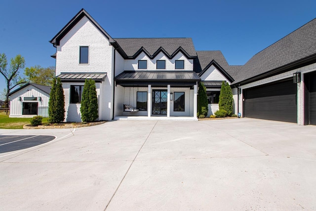 7509 S Shoreline, Benton, AR 72019 - modern farmhouse featuring a standing seam roof, a metal roof, concrete driveway, and a shingled roof