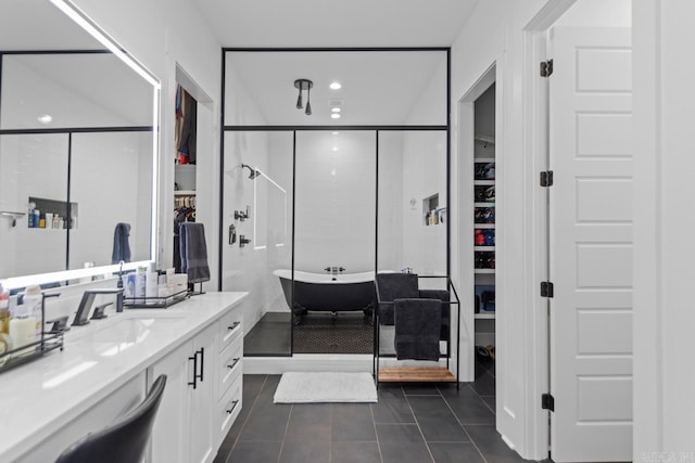 7509 S Shoreline, Benton, AR 72019 - bathroom with a spacious closet, vanity, a shower stall, a freestanding tub, and tile patterned floors