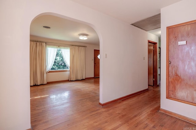 5302 A St, Little Rock, AR 72205 - empty room featuring arched walkways and light wood-style floors