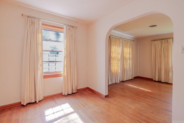 5302 A St, Little Rock, AR 72205 - unfurnished room featuring arched walkways and light wood finished floors