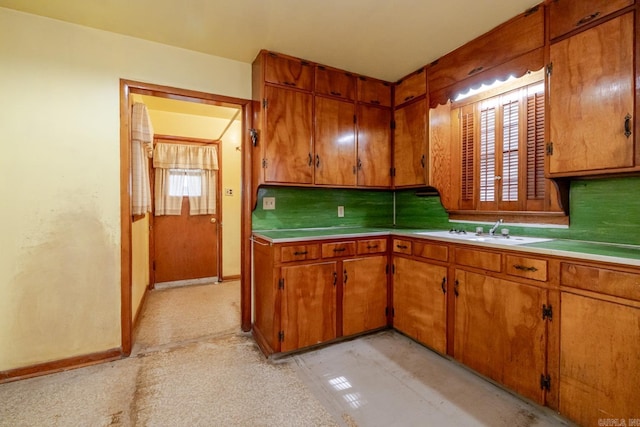 5302 A St, Little Rock, AR 72205 - kitchen with brown cabinets, tasteful backsplash, and light countertops