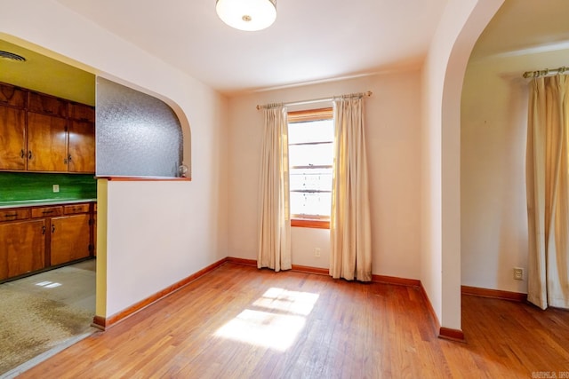5302 A St, Little Rock, AR 72205 - spare room featuring arched walkways and light wood-style floors