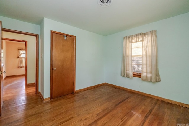5302 A St, Little Rock, AR 72205 - unfurnished bedroom with wood finished floors and a closet