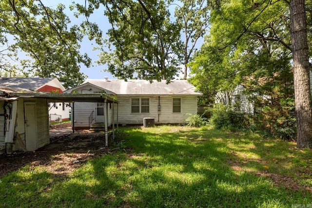 5302 A St, Little Rock, AR 72205 - back of property with a detached carport, entry steps, a lawn, and an outdoor structure