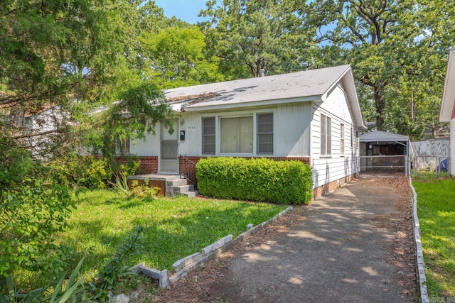 5302 A St, Little Rock, AR 72205 - view of front of property with driveway, brick siding, and a carport