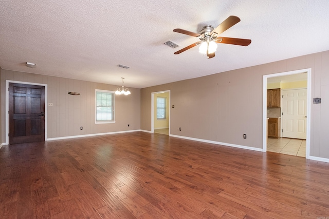 304 Dogwood Dr, Benton, AR 72019 - empty room featuring a chandelier, a ceiling fan, wood finished floors, and a textured ceiling