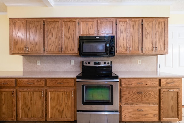 304 Dogwood Dr, Benton, AR 72019 - kitchen with stainless steel electric range oven, black microwave, crown molding, light countertops, and backsplash