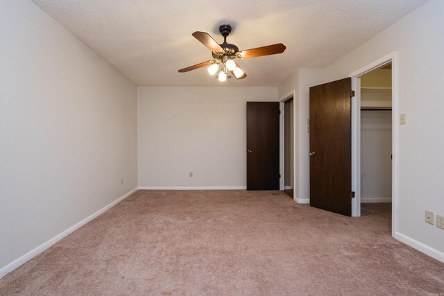304 Dogwood Dr, Benton, AR 72019 - unfurnished bedroom featuring a walk in closet, carpet floors, a ceiling fan, a closet, and a textured ceiling