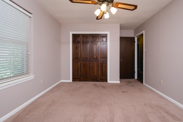 304 Dogwood Dr, Benton, AR 72019 - unfurnished bedroom featuring a textured ceiling, light carpet, a closet, and ceiling fan