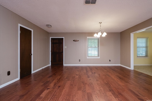 304 Dogwood Dr, Benton, AR 72019 - empty room featuring a chandelier, dark wood-style floors, and a textured ceiling