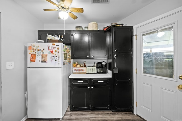 1324 Sunset Dr, Conway, AR 72034 - kitchen featuring freestanding refrigerator, dark cabinets, ceiling fan, wood finished floors, and light countertops