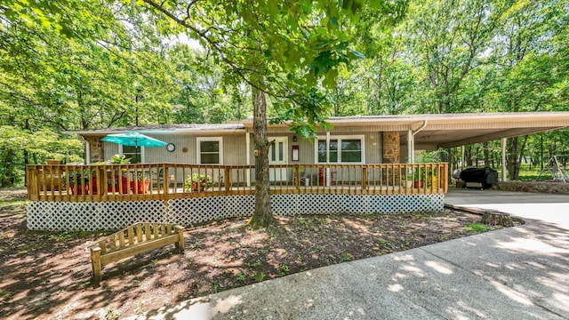 424 Center Rdg, Drasco, AR 72543 - ranch-style home with driveway, an attached carport, and a wooden deck