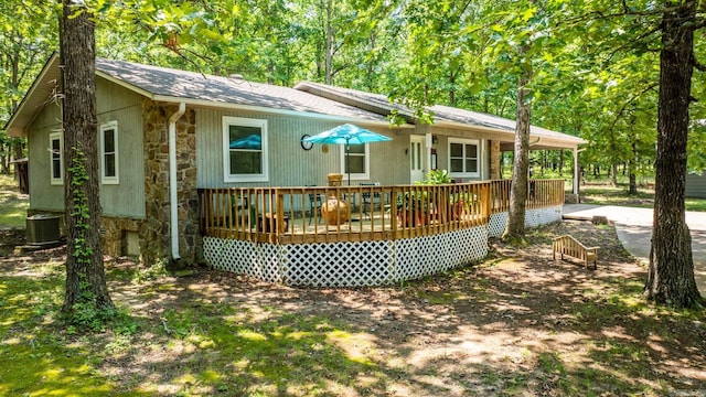 424 Center Rdg, Drasco, AR 72543 - rear view of house featuring stone siding, a wooden deck, and roof with shingles