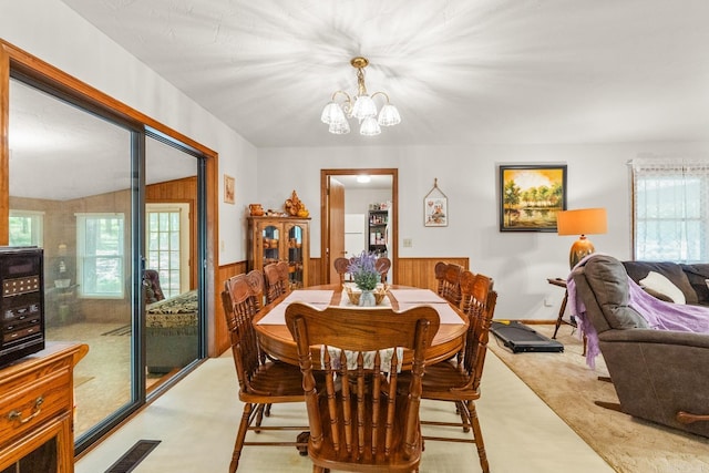 424 Center Rdg, Drasco, AR 72543 - dining room with plenty of natural light, a wainscoted wall, a chandelier, and wood walls