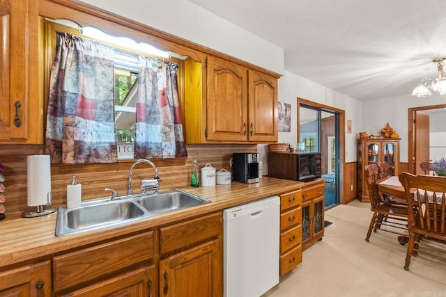424 Center Rdg, Drasco, AR 72543 - kitchen with dishwasher, black microwave, brown cabinets, and a chandelier