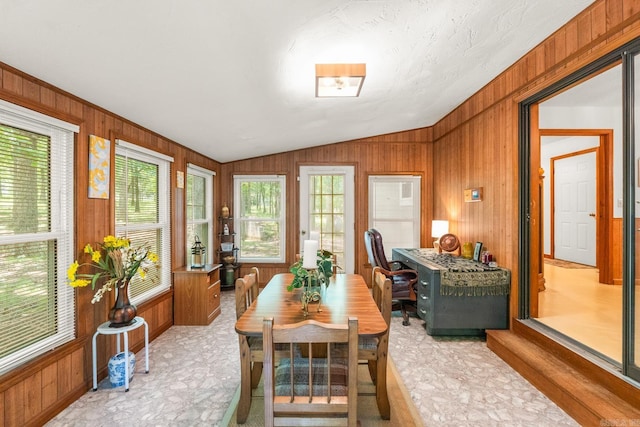 424 Center Rdg, Drasco, AR 72543 - dining area with healthy amount of natural light, wooden walls, lofted ceiling, and light floors